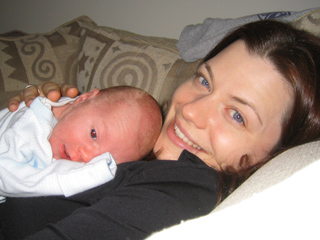 the wee baby cole and the gui girl enjoy a little snuggle time.